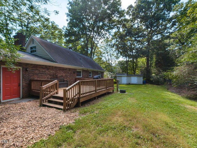 1831 Washington Dr, Hillsborough, NC 27278 - view of grassy yard with a deck and a storage shed