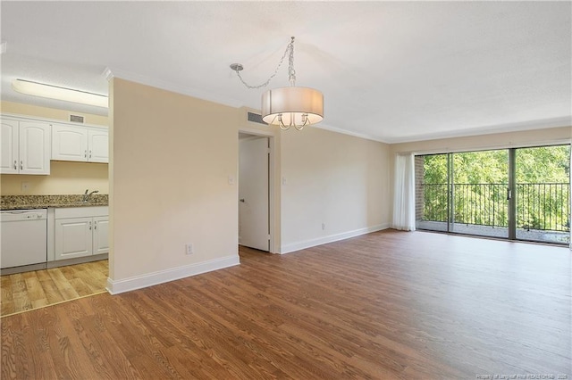 1100 Clarendon St Unit 303, Fayetteville, NC 28305 - spare room with light wood finished floors, crown molding, and a chandelier