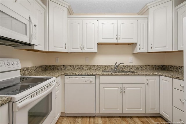 1100 Clarendon St Unit 303, Fayetteville, NC 28305 - kitchen with white appliances, white cabinetry, and light wood-type flooring