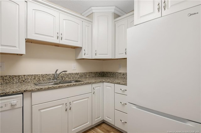 1100 Clarendon St Unit 303, Fayetteville, NC 28305 - kitchen featuring white appliances, white cabinetry, light stone countertops, and light wood-type flooring