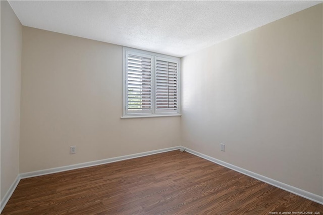 1100 Clarendon St Unit 303, Fayetteville, NC 28305 - empty room with dark wood-style floors and a textured ceiling