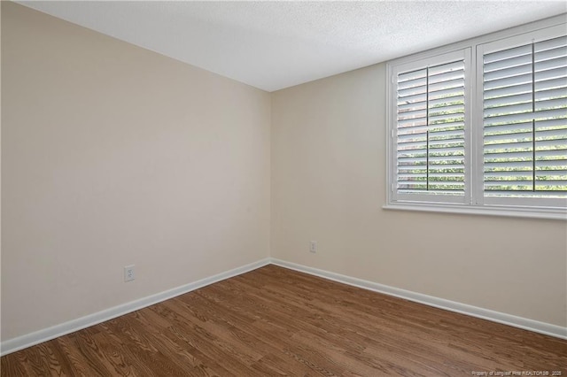 1100 Clarendon St Unit 303, Fayetteville, NC 28305 - unfurnished room featuring wood finished floors and a textured ceiling