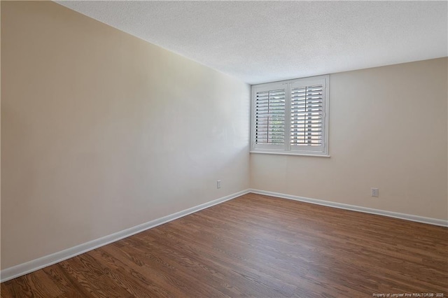 1100 Clarendon St Unit 303, Fayetteville, NC 28305 - spare room with dark wood-style floors and a textured ceiling