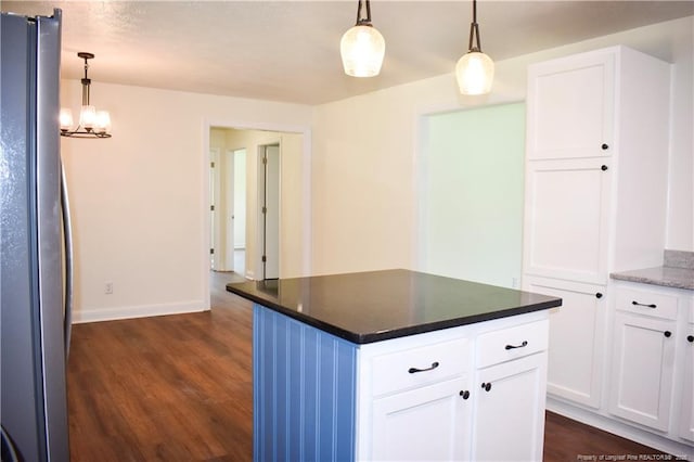 5404 S Sumac Cir, Fayetteville, NC 28304 - kitchen featuring freestanding refrigerator, dark wood-type flooring, white cabinets, decorative light fixtures, and dark countertops