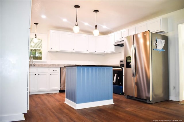5404 S Sumac Cir, Fayetteville, NC 28304 - kitchen with appliances with stainless steel finishes, under cabinet range hood, dark wood finished floors, white cabinets, and a center island