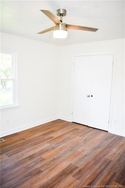 5404 S Sumac Cir, Fayetteville, NC 28304 - unfurnished bedroom with wood finished floors, a ceiling fan, and a closet