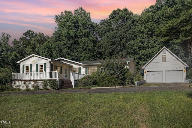 5807 Craig Rd, Durham, NC 27712 - view of front of property featuring a porch, a front yard, a garage, and an outbuilding