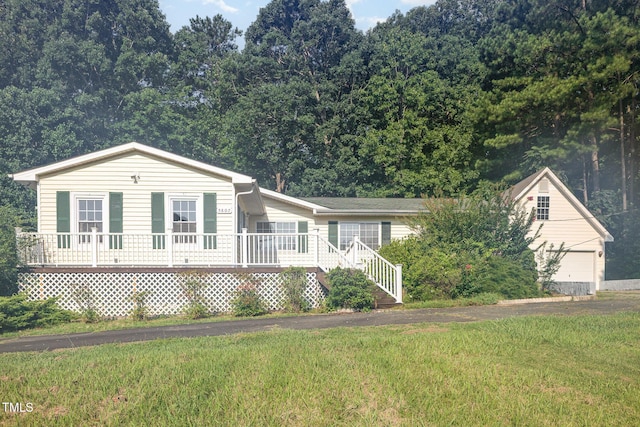 5807 Craig Rd, Durham, NC 27712 - view of front of property with a front yard and a wooden deck