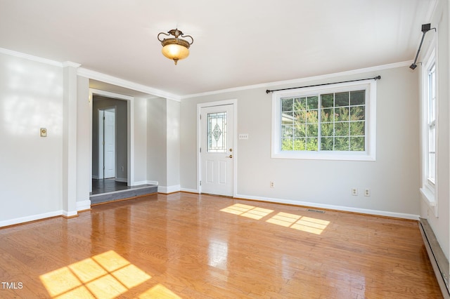 5807 Craig Rd, Durham, NC 27712 - foyer entrance with a baseboard heating unit, crown molding, and wood finished floors