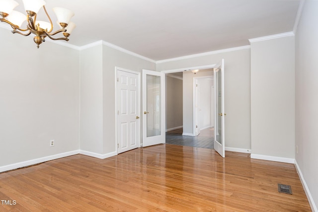 5807 Craig Rd, Durham, NC 27712 - spare room with a chandelier, light wood finished floors, and ornamental molding