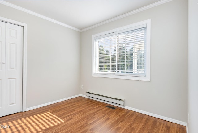 5807 Craig Rd, Durham, NC 27712 - unfurnished room featuring baseboard heating, wood finished floors, and ornamental molding