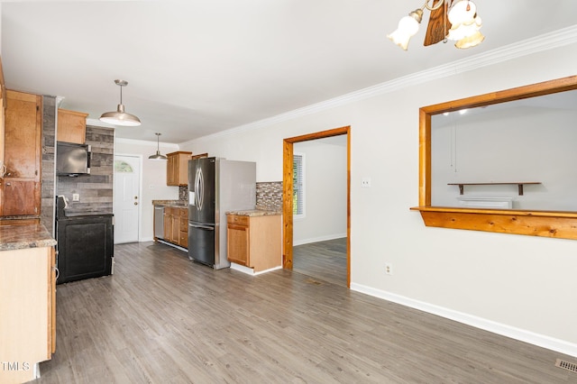 5807 Craig Rd, Durham, NC 27712 - kitchen featuring stainless steel appliances, decorative backsplash, crown molding, wood finished floors, and a chandelier