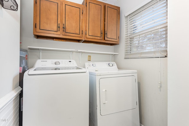 5807 Craig Rd, Durham, NC 27712 - laundry room featuring washer and clothes dryer and cabinet space