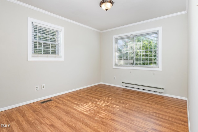 5807 Craig Rd, Durham, NC 27712 - spare room with a baseboard heating unit, healthy amount of natural light, ornamental molding, and wood finished floors