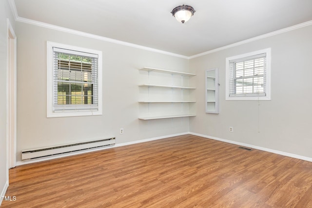 5807 Craig Rd, Durham, NC 27712 - spare room featuring a baseboard heating unit, crown molding, light wood-type flooring, and plenty of natural light