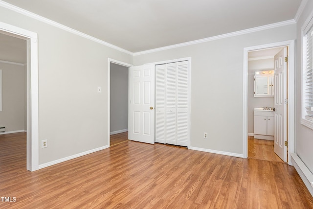 5807 Craig Rd, Durham, NC 27712 - unfurnished bedroom featuring light wood-style flooring, ornamental molding, and a closet