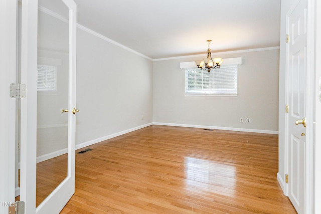 5807 Craig Rd, Durham, NC 27712 - spare room with a chandelier, crown molding, and light wood finished floors