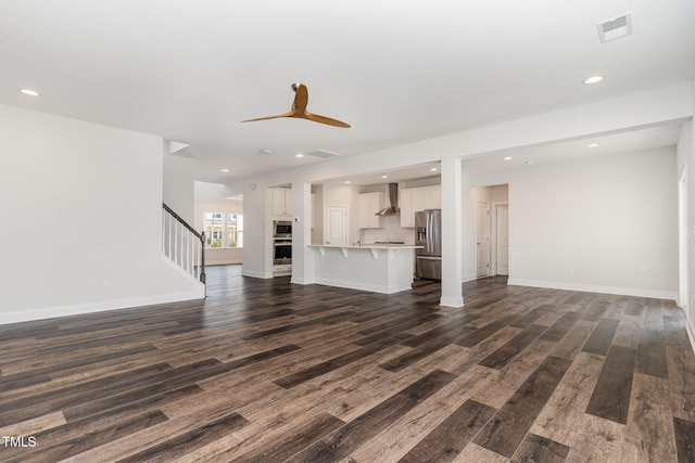 3409 Table Mountain Pine Dr, Raleigh, NC 27616 - unfurnished living room with dark wood-style flooring, stairs, recessed lighting, and ceiling fan