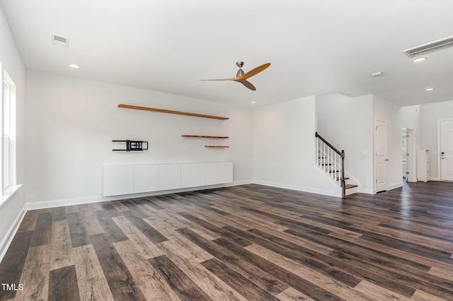 3409 Table Mountain Pine Dr, Raleigh, NC 27616 - unfurnished living room with dark wood-style floors, stairway, ceiling fan, and recessed lighting