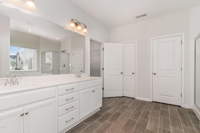 3409 Table Mountain Pine Dr, Raleigh, NC 27616 - full bathroom featuring a stall shower, double vanity, and wood finished floors