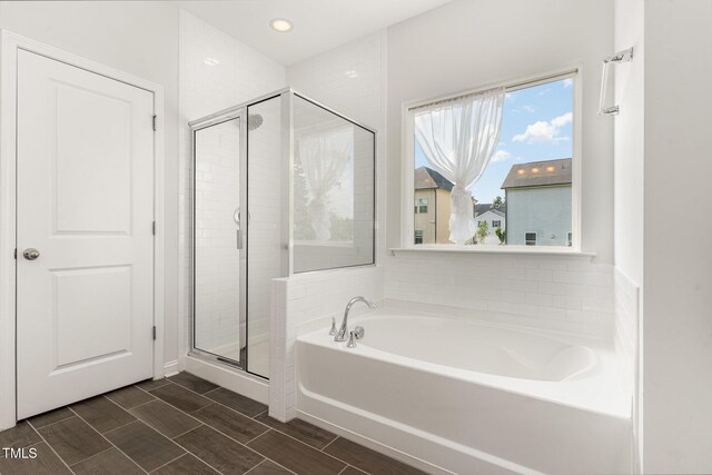 3409 Table Mountain Pine Dr, Raleigh, NC 27616 - bathroom featuring a garden tub, a shower stall, and recessed lighting