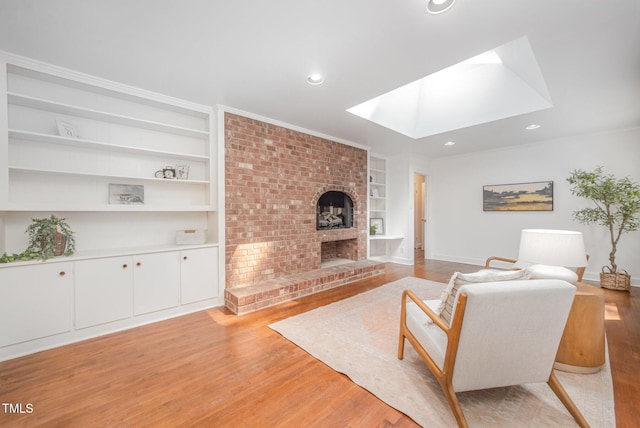 2425 Wentworth St, Raleigh, NC 27612 - living area featuring built in features, a skylight, light wood finished floors, a fireplace, and recessed lighting