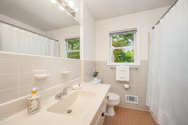 2425 Wentworth St, Raleigh, NC 27612 - full bathroom featuring tile walls, vanity, wainscoting, and curtained shower