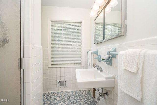 2425 Wentworth St, Raleigh, NC 27612 - full bathroom featuring tile walls, a shower stall, and a wainscoted wall