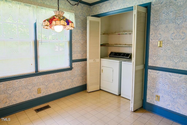 205 Forest Rd, Oxford, NC 27565 - laundry area featuring wallpapered walls, washer and dryer, and light tile patterned floors