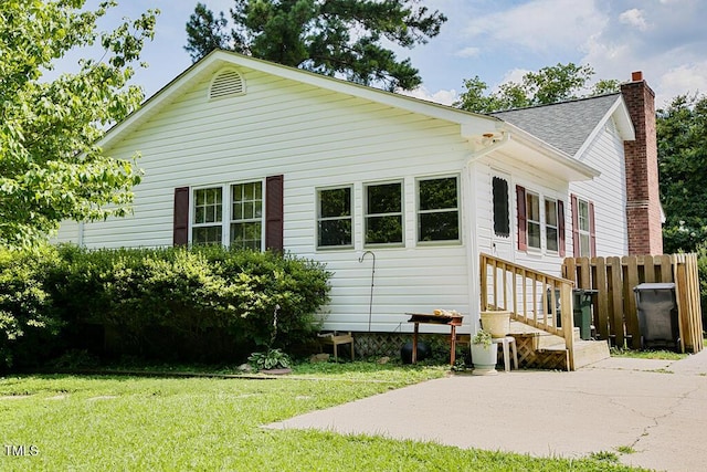 205 Forest Rd, Oxford, NC 27565 - rear view of property featuring a chimney, a patio, and a shingled roof