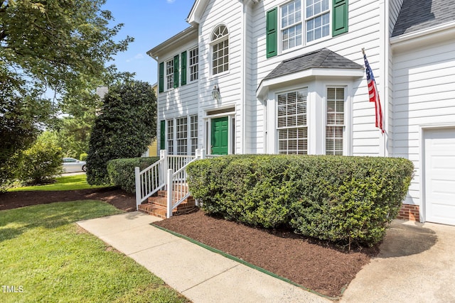 1401 Patterson Grove Rd, Apex, NC 27502 - entrance to property featuring a garage, a yard, and a shingled roof
