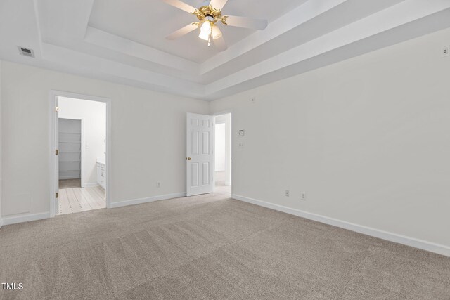 1401 Patterson Grove Rd, Apex, NC 27502 - unfurnished bedroom with light carpet, a tray ceiling, and ensuite bath