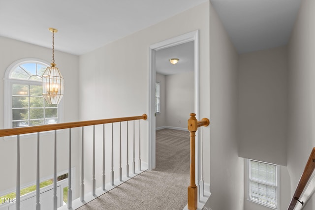 1401 Patterson Grove Rd, Apex, NC 27502 - hallway featuring a chandelier, carpet flooring, and an upstairs landing