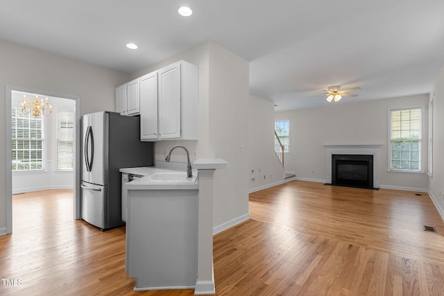 1401 Patterson Grove Rd, Apex, NC 27502 - kitchen with freestanding refrigerator, light countertops, light wood-type flooring, ceiling fan, and recessed lighting