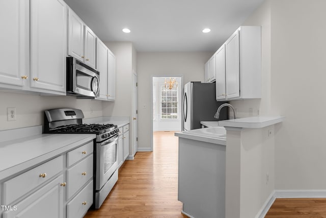 1401 Patterson Grove Rd, Apex, NC 27502 - kitchen with appliances with stainless steel finishes, light wood finished floors, white cabinets, light countertops, and recessed lighting