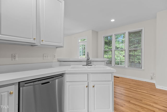 1401 Patterson Grove Rd, Apex, NC 27502 - kitchen featuring stainless steel dishwasher, light wood-style floors, white cabinetry, light countertops, and recessed lighting
