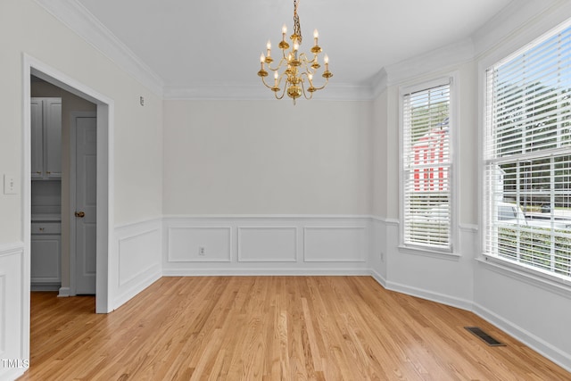 1401 Patterson Grove Rd, Apex, NC 27502 - unfurnished dining area featuring healthy amount of natural light, a chandelier, light wood-type flooring, crown molding, and wainscoting