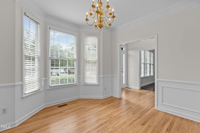 1401 Patterson Grove Rd, Apex, NC 27502 - unfurnished dining area with a chandelier, light wood-type flooring, crown molding, and healthy amount of natural light