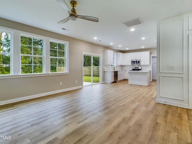 197 Delma Grimes Rd, Coats, NC 27521 - unfurnished living room with a ceiling fan, light wood-style flooring, and recessed lighting