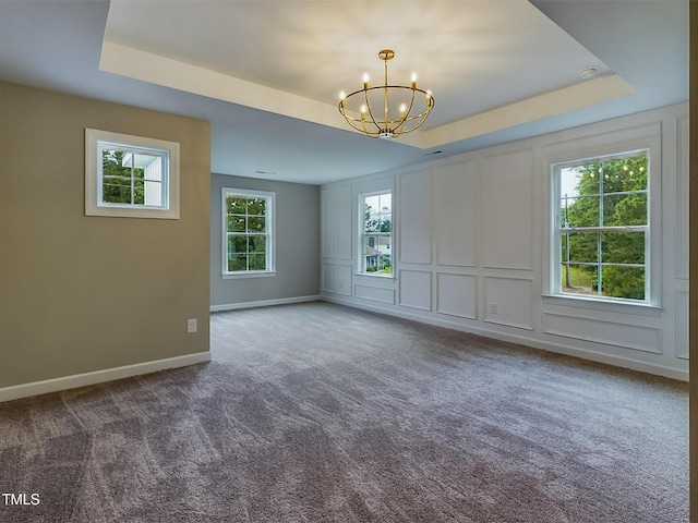 197 Delma Grimes Rd, Coats, NC 27521 - unfurnished room with carpet, a chandelier, a raised ceiling, and a decorative wall