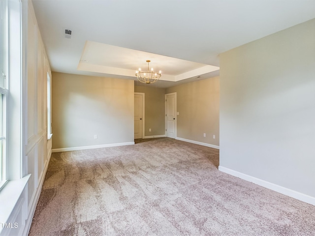 197 Delma Grimes Rd, Coats, NC 27521 - spare room with a tray ceiling, a chandelier, and carpet floors