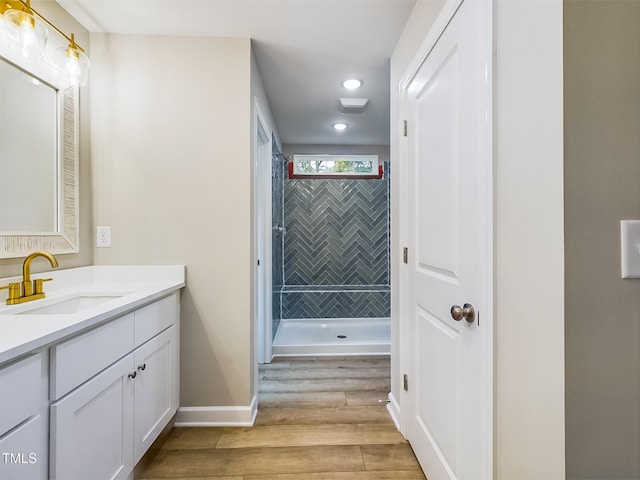 197 Delma Grimes Rd, Coats, NC 27521 - full bathroom with vanity, wood finished floors, recessed lighting, and a tile shower