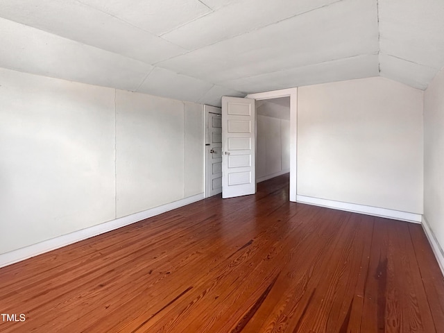 1116 E Martin St, Raleigh, NC 27610 - spare room with vaulted ceiling and dark wood-style flooring