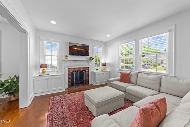 1116 E Martin St, Raleigh, NC 27610 - living room with wood finished floors, a brick fireplace, and recessed lighting