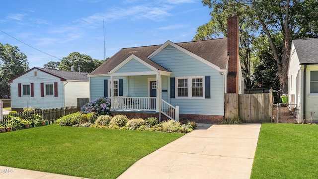 1116 E Martin St, Raleigh, NC 27610 - bungalow featuring covered porch, a chimney, and roof with shingles