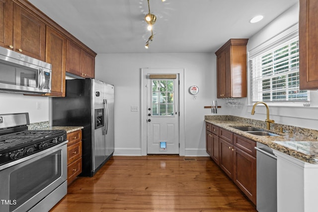 1116 E Martin St, Raleigh, NC 27610 - kitchen featuring appliances with stainless steel finishes, dark wood finished floors, and light stone countertops