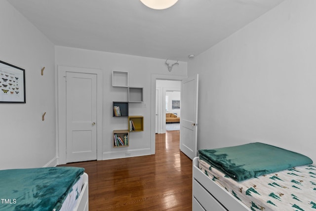 1116 E Martin St, Raleigh, NC 27610 - bedroom with dark wood-style floors and baseboards