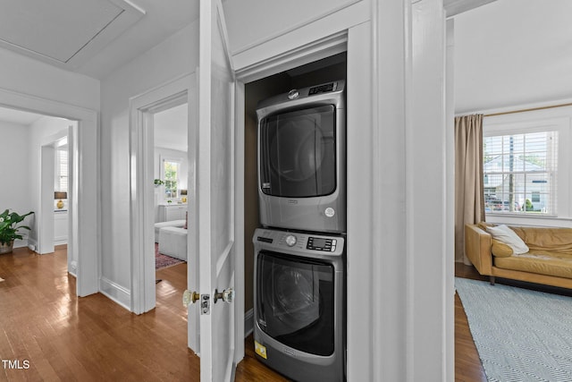 1116 E Martin St, Raleigh, NC 27610 - laundry area featuring estacked washer and dryer, wood finished floors, and attic access
