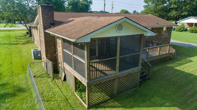 410 Sherron Rd, Durham, NC 27703 - back of house with roof with shingles, a chimney, a sunroom, and brick siding