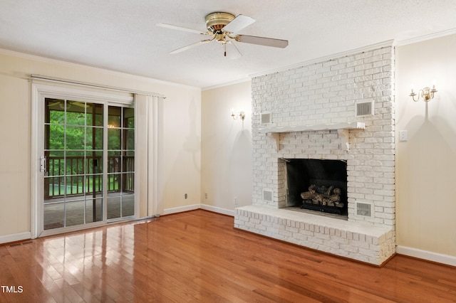 410 Sherron Rd, Durham, NC 27703 - unfurnished living room featuring wood finished floors, crown molding, a brick fireplace, ceiling fan, and a textured ceiling